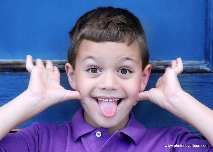 child_boy_blue_door_funny_face.jpg
